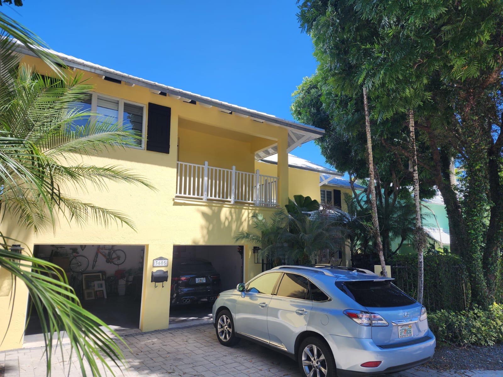 Exterior of a yellow South Florida home serviced by LL Superior Multi Services